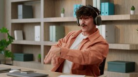 Funny happy guy Caucasian male businessman entrepreneur office employee business man at workplace dance listen music song in headphones phone audio online app working indoor dancing relax break fun - Powered by Shutterstock - Get 15% off with code: PIKWIZARD15