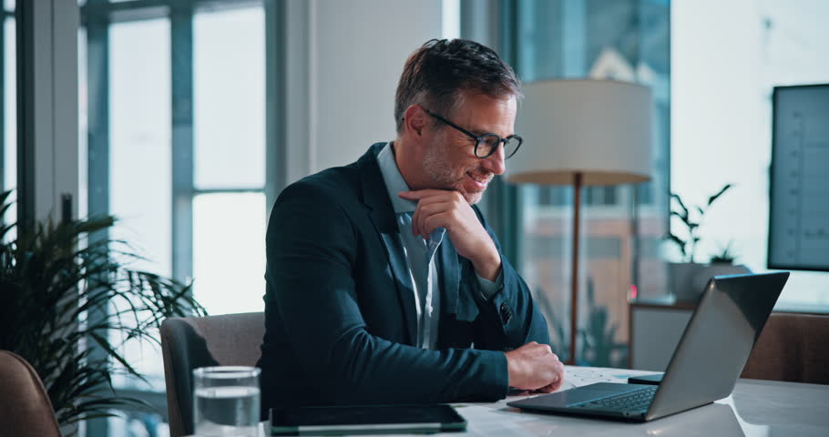 Mature man, celebration and laptop in office for profit, growth and roi with smile at financial agency. Person, investor and success on stock market with cheers, goals and trading bonus at company
