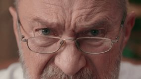 Close up cropped view angry old Caucasian man eyes male irritated glasses half face pensioner elderly businessman mature indoor looking at camera furious portrait expression annoyed headshot mad anger - Powered by Shutterstock - Get 15% off with code: PIKWIZARD15