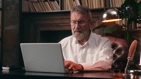 Caucasian old elderly man typing laptop desktop computer working online internet e-business mature male businessman business home office project senior email message indoors entrepreneur e-commerce - Powered by Shutterstock - Get 15% off with code: PIKWIZARD15
