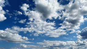 White fluffy clouds moving on blue sky at summer sunny day. Beautiful nature background. Time lapse Close up - Powered by Shutterstock - Get 15% off with code: PIKWIZARD15