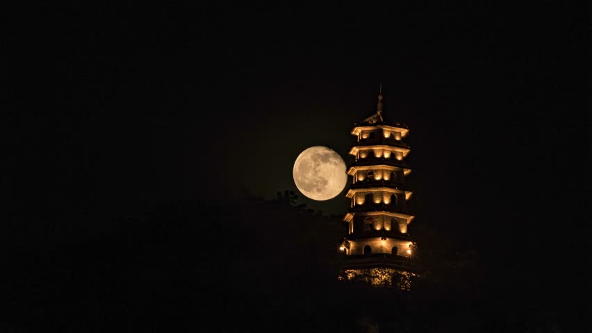 A time-lapse view of the full moon rising behind a pagoda in Liuzhou, Guangxi, China