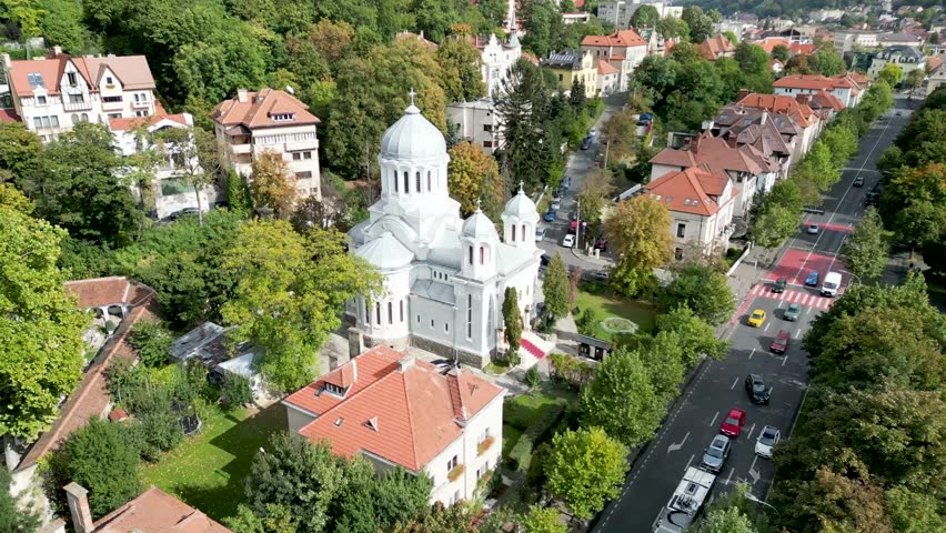 A drone footage of the Orthodox Church of the Annunciation (Biserica Buna Vestire) and the nearby buildings in Brasov, Romania