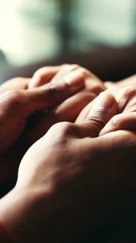 Holding hands, compassion and couple with love, home and closeup of people in relationship or empathy. Comforting, partners and understanding for romance on date, care and bonding on Valentines day