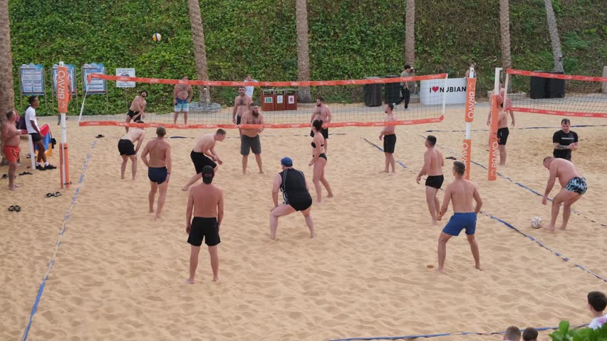 February 7, 2025, Sharm El Sheikh, Egypt. Energetic players engage in a thrilling beach volleyball match, showcasing skill and teamwork on golden sands surrounded by palm trees.
