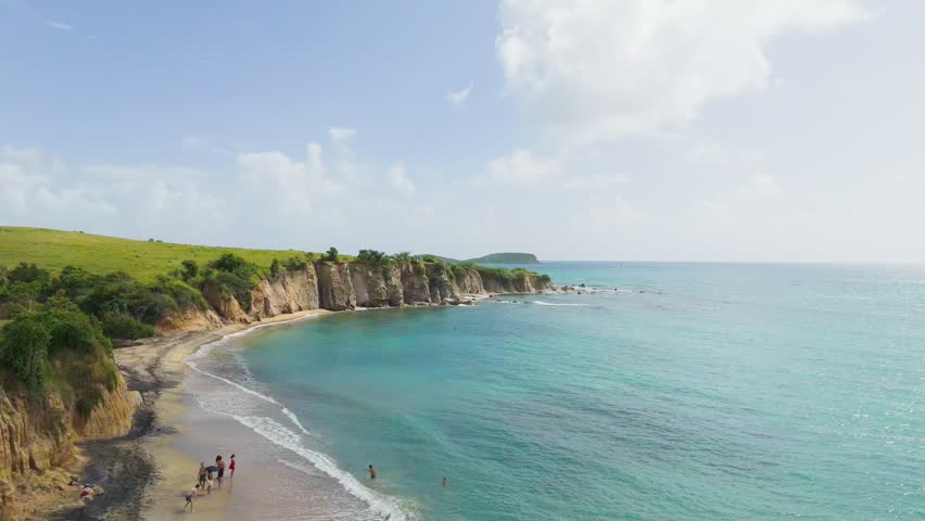 An ascending aerial view of the Black Sand Beach (Playa Negra) on a sunny day in Vieques, Puerto Rico