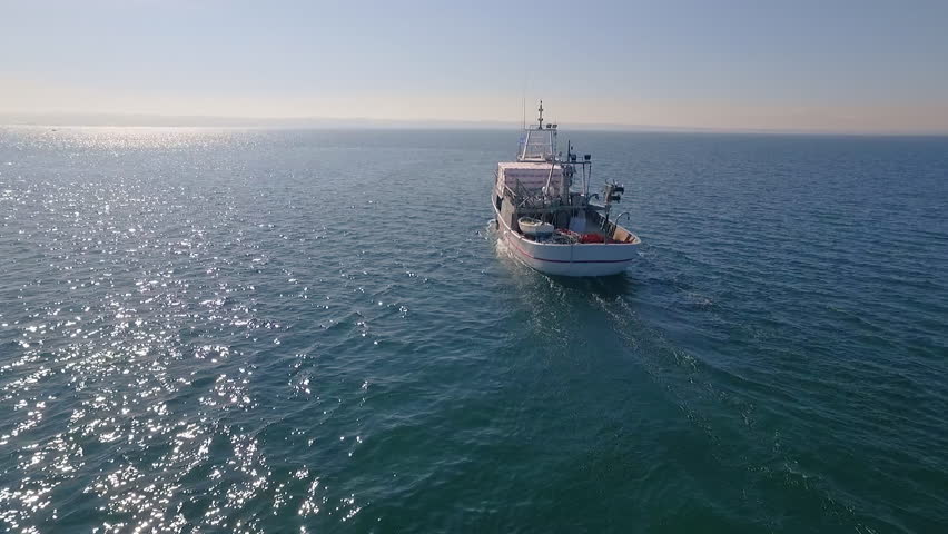 Aerial view, fishing boat sets out to sea for fishing