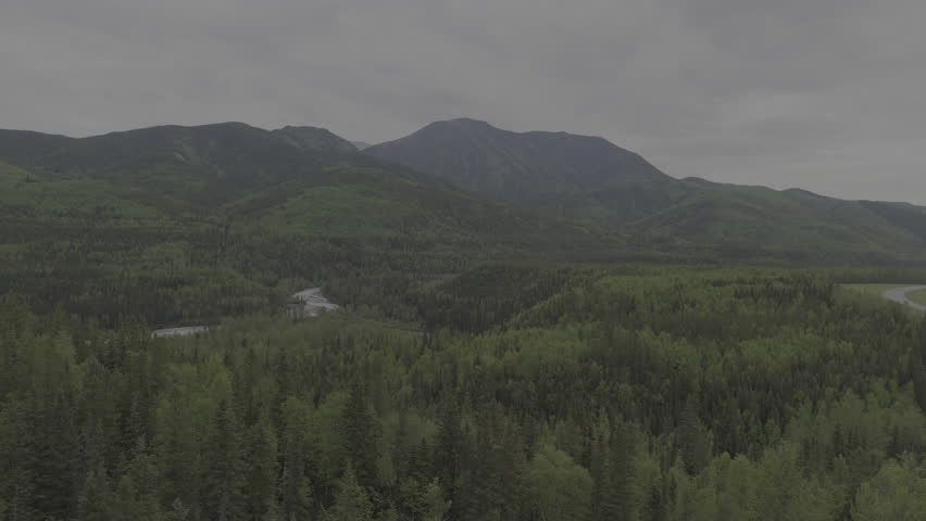 A vast Yukon wilderness with rivers, forests, and mountain views.