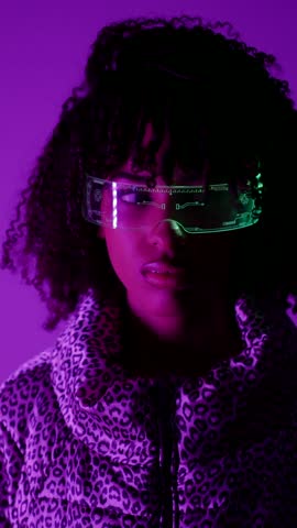 Stylish woman showcasing different colored futuristic goggles against a vibrant purple backdrop