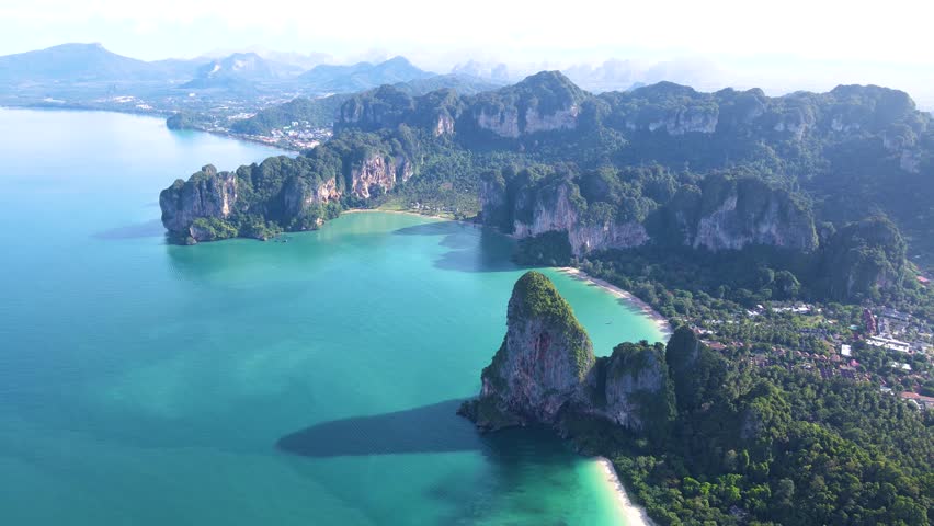 Discover the serene beauty of Krabi Thailand, where turquoise waters meet magnificent cliffs. Soak in the tranquility and natural wonders of this tropical paradise. Railay beach