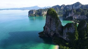 Experience the breathtaking beauty of Railay Beach Krabi Thailand from above. The vibrant turquoise waters meet majestic limestone cliffs, creating a stunning landscape that captivates all who visit. - Powered by Shutterstock - Get 15% off with code: PIKWIZARD15
