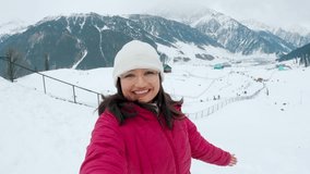 4K Selfie video of teenager Indian girl enjoying holidays in snowy mountains at Sonmarg, Kashmir, India. Tourist showing snowy winter landscape in selfie video. Selfie shot. - Powered by Shutterstock - Get 15% off with code: PIKWIZARD15