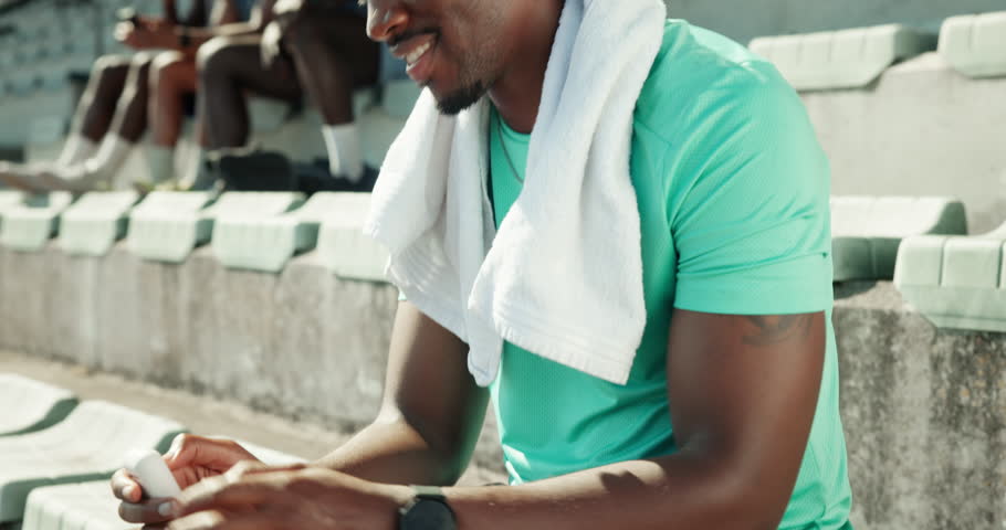 Music, happy and runner with man in stadium for streaming, workout playlist and competition practice. Marathon training, radio and earphones with person in arena for sports athlete, fitness and audio