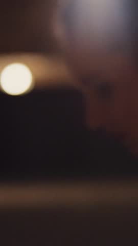 A lone figure stands in dim light, enhancing mystery and tension