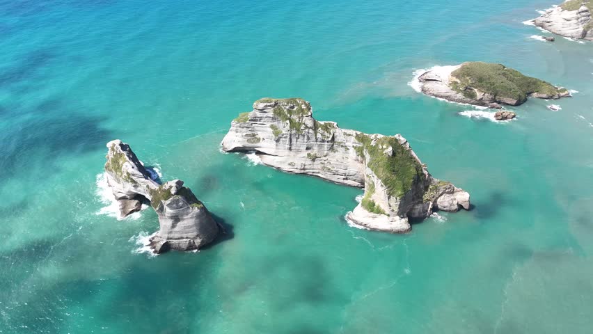 A drone view of rock formations at Wharariki Beach on the Tasman Sea, west of Cape Farewell, the northernmost point of the South Island of New Zealand