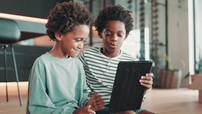 Home, happy and children with tablet on floor for relax, online games and playing together. African family, siblings and young boys on digital tech for streaming cartoons, watching movies or videos - Powered by Shutterstock - Get 15% off with code: PIKWIZARD15