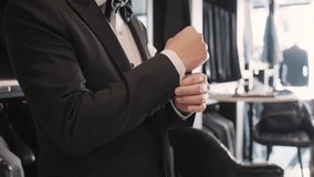 Close up young adult happy man asia people prepare clothes for tied knot wedding life event party get dressed up wear cuff link bow tie try on full male suit at fitting room modern luxury shirt store. - Powered by Shutterstock - Get 15% off with code: PIKWIZARD15