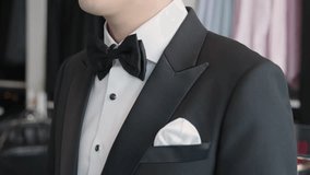 Close up young adult happy man asia people prepare clothes for tied knot wedding life event party get dressed up wear cuff link bow tie try on full male suit at fitting room modern luxury shirt store. - Powered by Shutterstock - Get 15% off with code: PIKWIZARD15