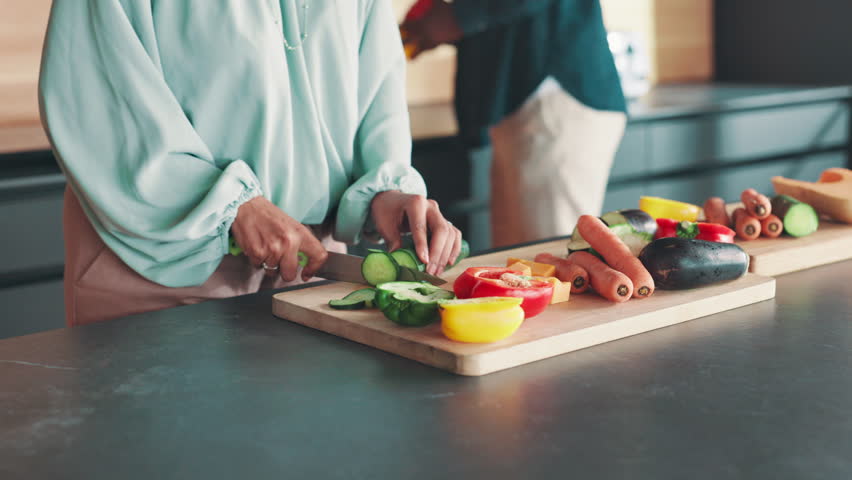 Kitchen, couple and hands with vegetables for cooking, nutrition and bonding together at home. House, man and woman with food for meal prep, healthy diet and support in marriage for dinner by closeup