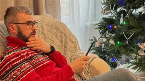 Cozy reading by the Christmas tree brings holiday warmth and joy - Powered by Shutterstock - Get 15% off with code: PIKWIZARD15