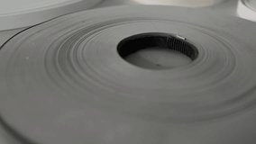 Pvc edge banding tape slowly unwinding on white background, showcasing manufacturing process and woodworking material with industrial precision - Powered by Shutterstock - Get 15% off with code: PIKWIZARD15