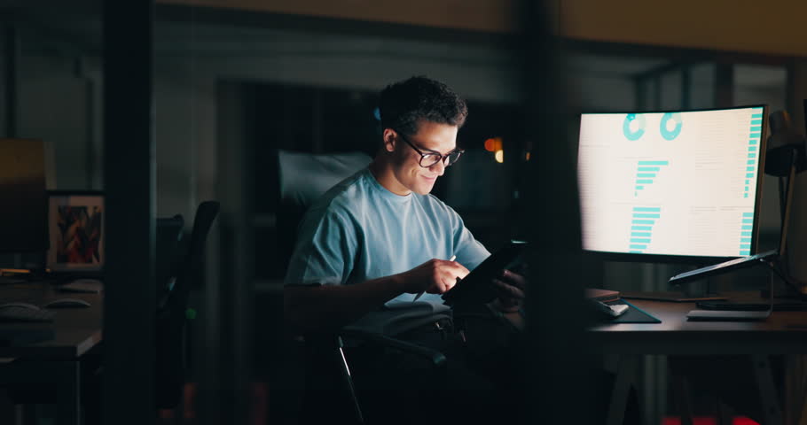 Laptop, night and tablet with business man in office for deadline, planning or research. Computer, investment and screen with international stock market trader in workplace for financial investment