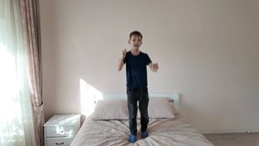 Smiling child jumping high on comfortable bed. Slow motion  - Powered by Shutterstock - Get 15% off with code: PIKWIZARD15
