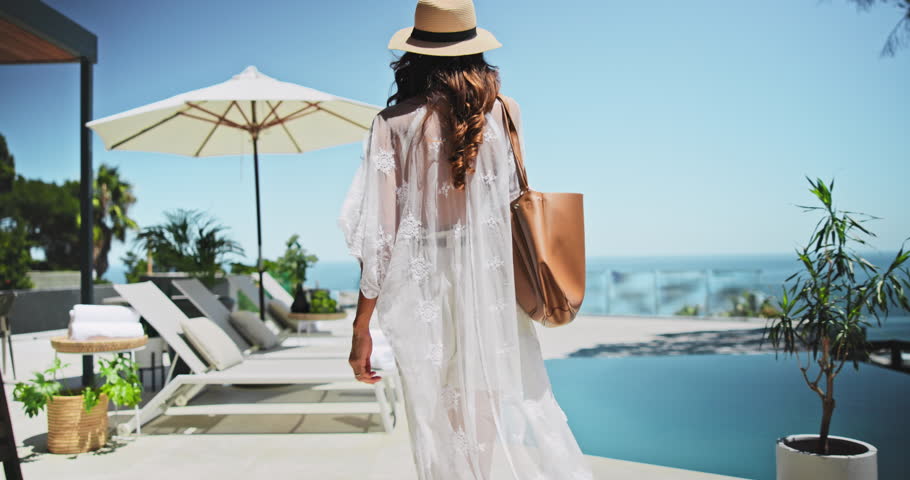 Sunbathing, relax and woman on resort, holiday and summer vacation for tourist, hotel or outdoor. Travel, luxury and person on getaway for rest, comfortable and break for traveller on trip or weekend