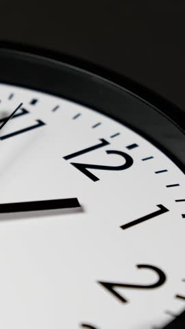 Clock face timelapse on black background. Time ticking on classic wall clock. Time moving fast. Time concept. Wall clock show running time. Vertical video. Close-up in 4K, UHD