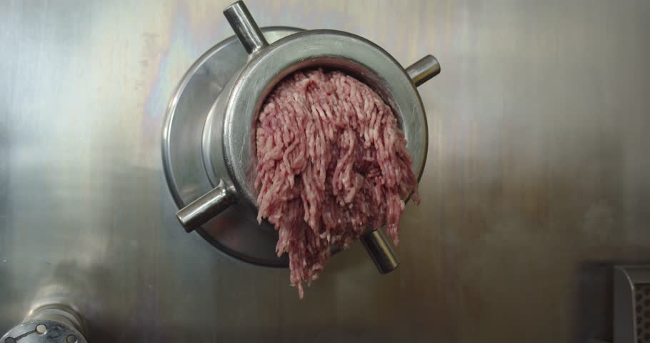 Industrial meat processing machine in a factory. Meat processing plant concept.