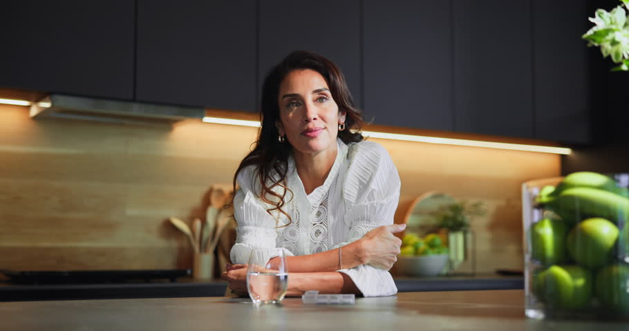 Woman, pill box and drinking water in home, supplements and vitamin b tablets for menopause. Kitchen, container and drugs storage for chronic treatment, medication and omega 3 to remedy condition