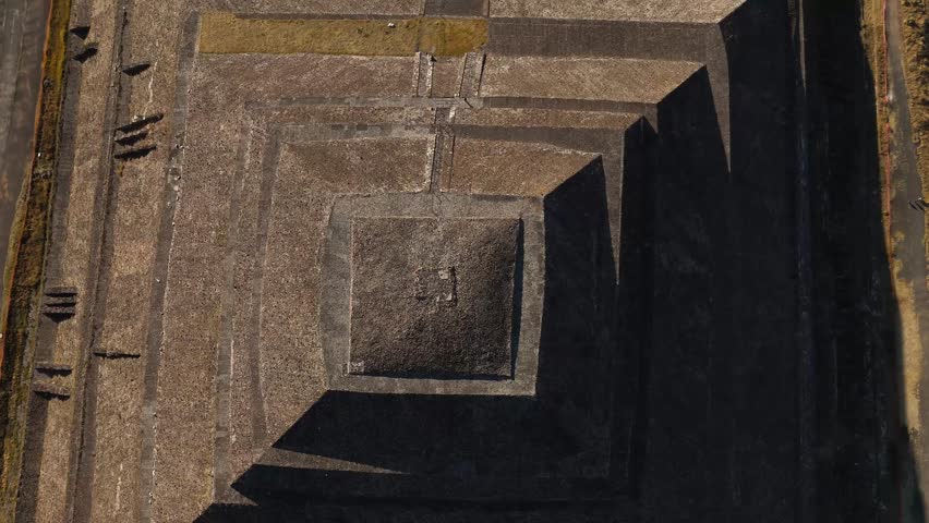 Overhead view of the Pyramid of the Sun at the archaeological site of Teotihuacan, Mexico. Drone camera moves overhead to the Avenue of the Dead