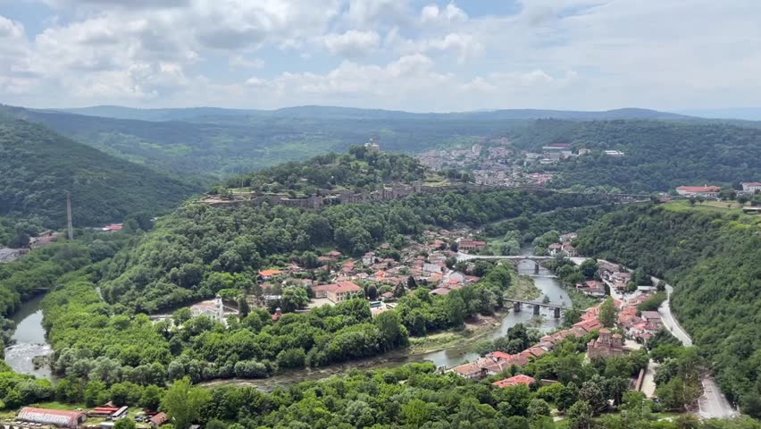 Veliko Tarnovo, Bulgaria, seen from a high vantage point. The Yantra River winds through the city, with Tsarevets Fortress standing prominently - Bulgaria, Europe