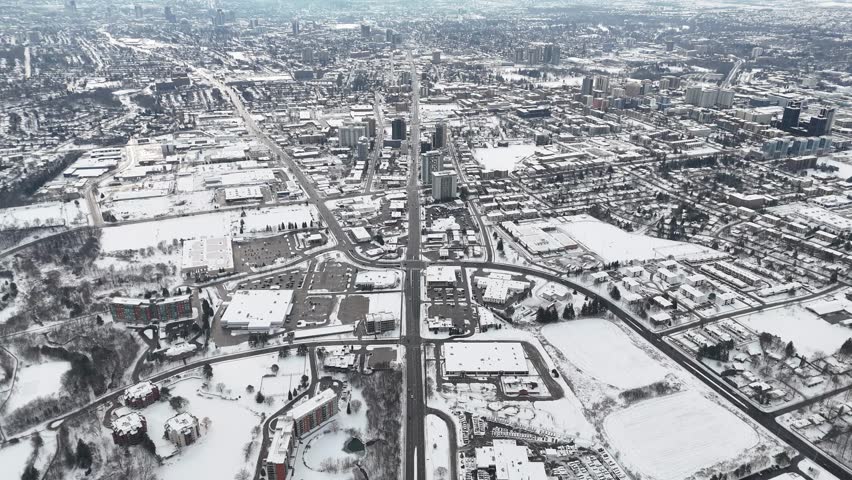 A drone view captures Kitchener, Ontario, blanketed in snow. The city