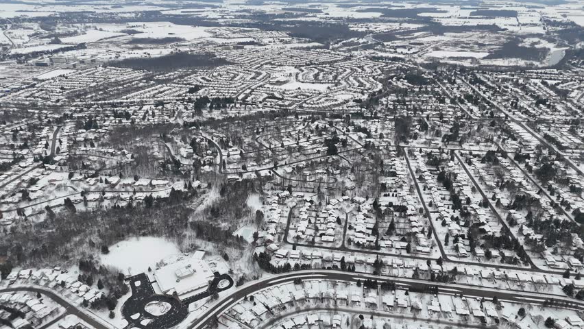 A breathtaking aerial view of the ice covering the roads, parks and buildings of Kitchener city in a deep winter day in Ontario, Canada