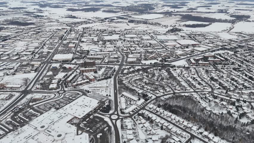 An aerial view of Kitchener, Ontario, blanketed in snow. The city