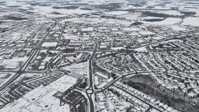 An aerial view of Kitchener, Ontario, blanketed in snow. The city's roads, rooftops, and parks are transformed into a peaceful winter landscape - Powered by Shutterstock - Get 15% off with code: PIKWIZARD15