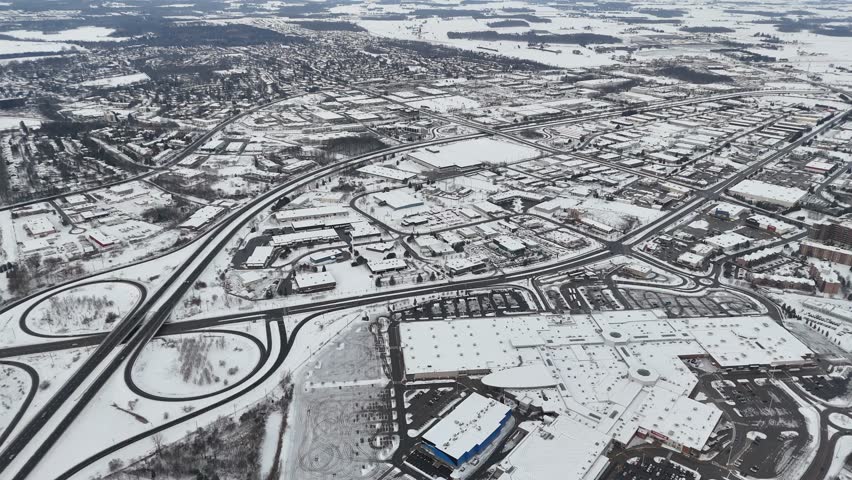 A drone view captures Kitchener, Ontario, blanketed in snow. The city