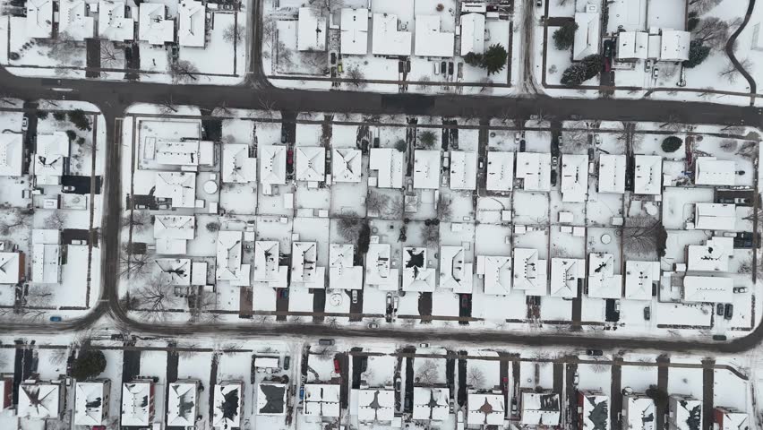 An aerial view over a snow-covered neighborhood with calm winter atmosphere in Kitchener, Ontario, Canada