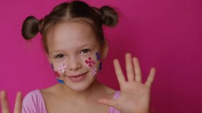A funny preschool-age girl without upper front teeth decorated her face with paper puzzle pieces - a common symbol of autism - Powered by Shutterstock - Get 15% off with code: PIKWIZARD15