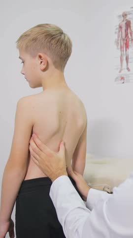Pediatric examination in a clinical setting emphasizes the importance of spinal alignment and the child's overall health