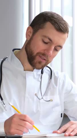 Medical professionals write notes during patient appointments for effective communication and care