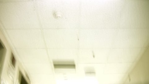 A hospital ceiling hallway leading to the emergency room