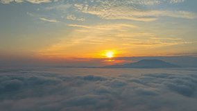 A serene view of the early morning sun rising above a vast sea of clouds, with distant mountain peaks faintly visible on the horizon, creating a peaceful and ethereal landscape. Flying over the cloud - Powered by Shutterstock - Get 15% off with code: PIKWIZARD15