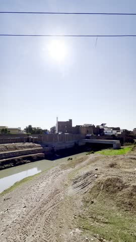 Water tumbles down rugged cliffs, sparkling in the sunlight as it crashes into the crystal-clear pool below. Mist rises into the air, cooling the surroundings, while lush green plants thrive 4k HD vid
