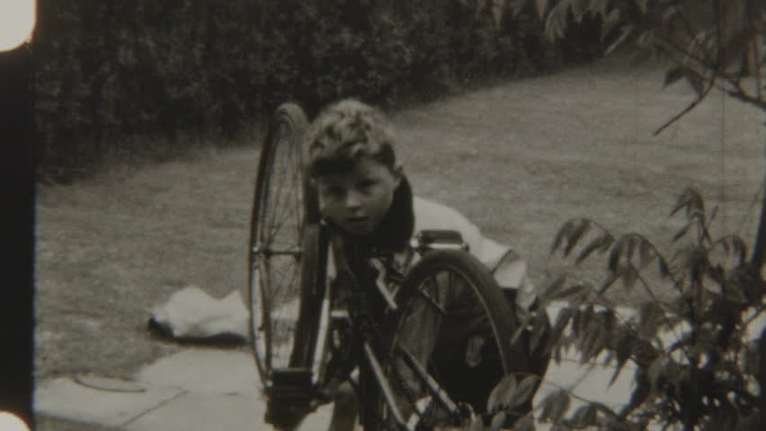 Child riding his bicycle across the backyard path, enjoying the outdoors and exploring the area