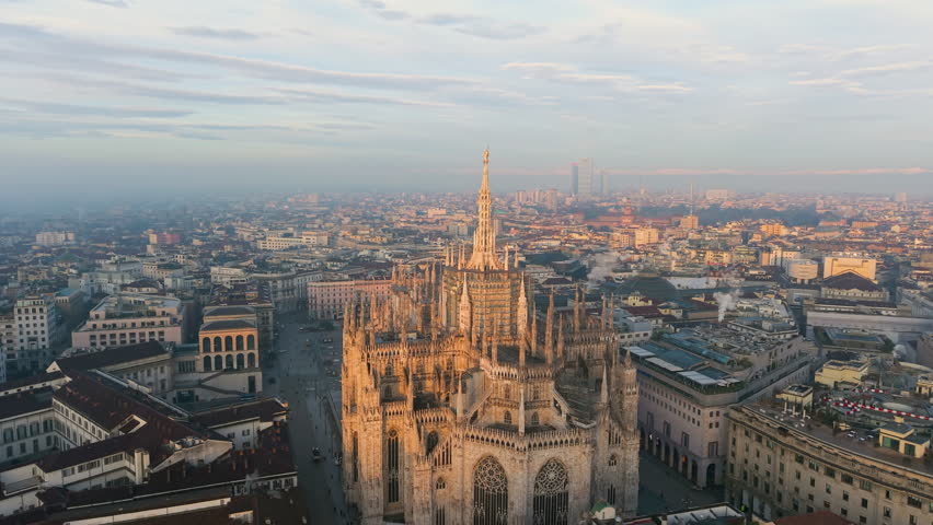 Aerial view of the central spire of the duomo and the city