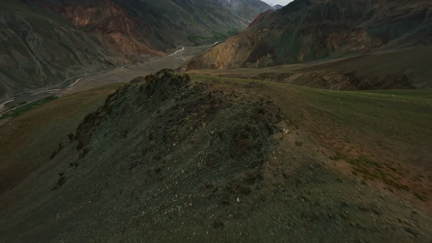 Himalayan mountains and green hills aerial view, FPV drone flight