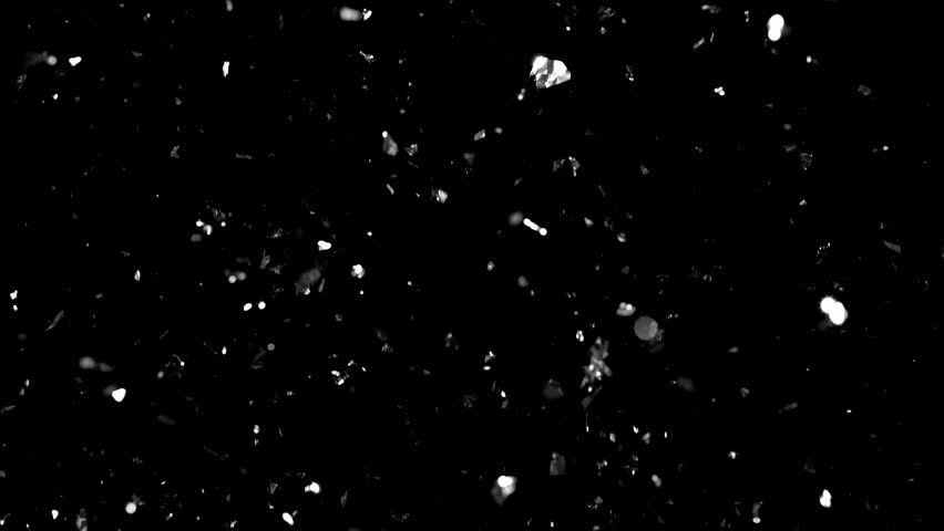 Slow-motion footage of glittering silver confetti gently drifting upward, creating a magical and serene atmosphere