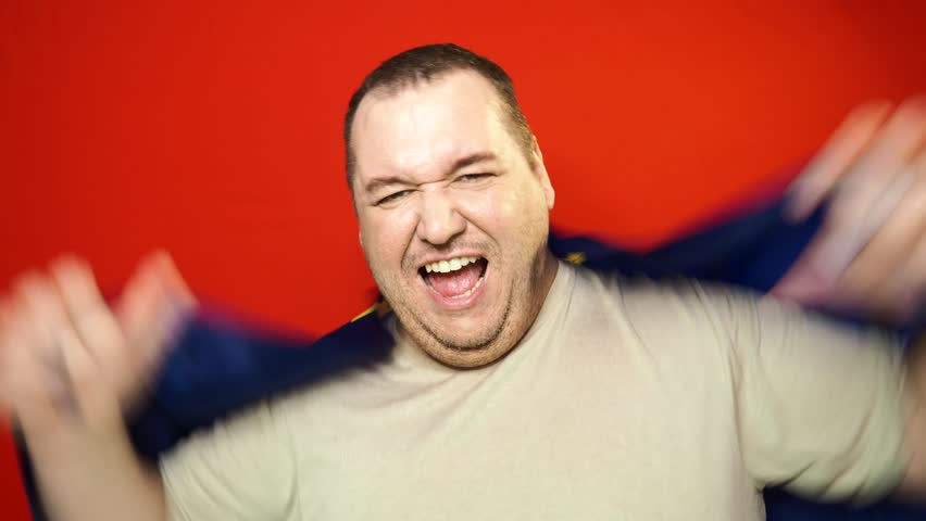 Adult funny man waving European flag. Pride and joy.